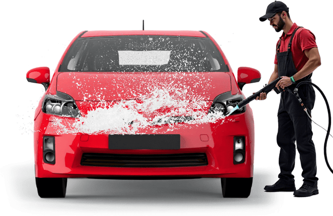 A car wash worker washing a red car with a pressure washer