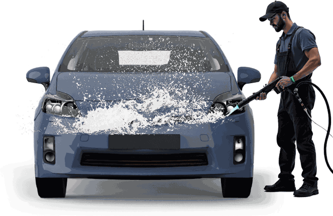 A car wash worker washing a red car with a pressure washer